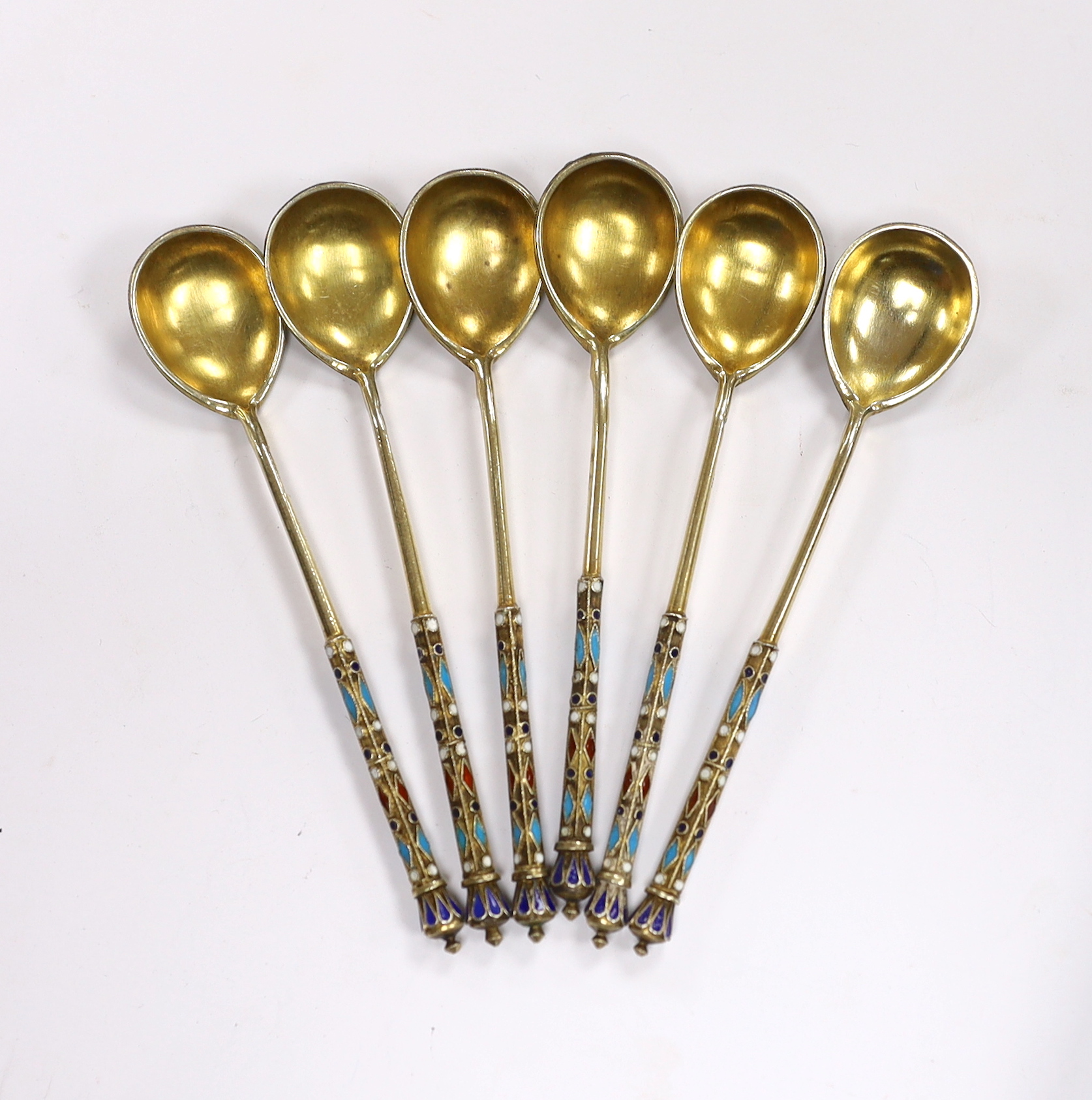 A set of six late 19th century Russian 84 zolotnik gilt white metal and cloisonné enamel coffee spoons, 11.4cm, gross 92 grams.